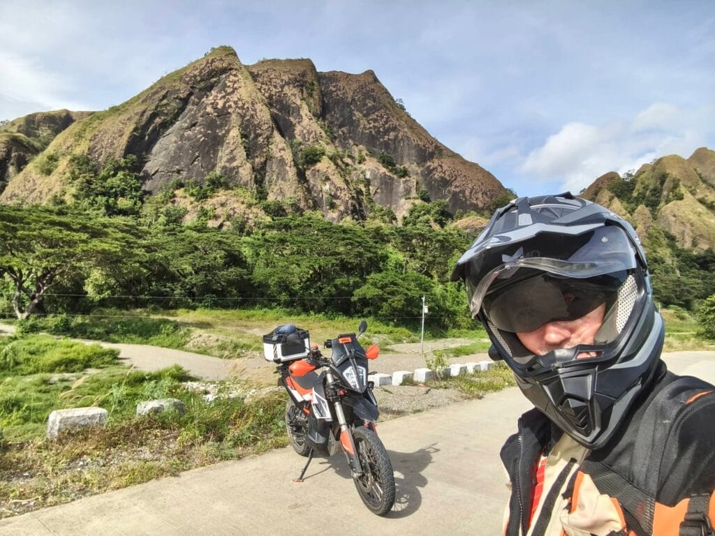 Motorcycle rider on a scenic road in the Philippines