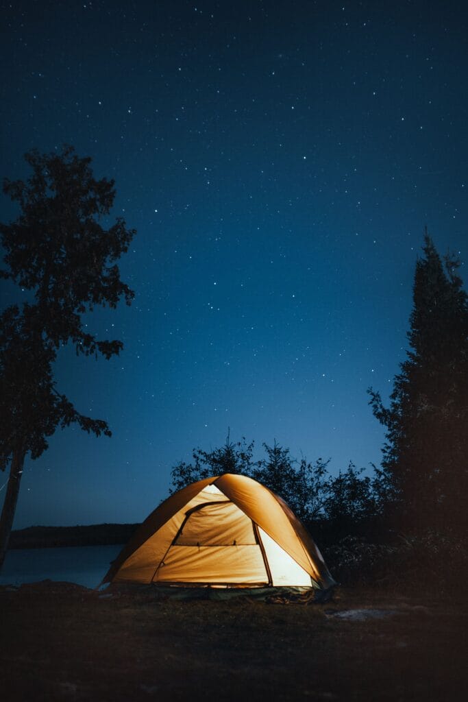Camping in the Philippines — tent pitched outdoors in lush tropical nature setting